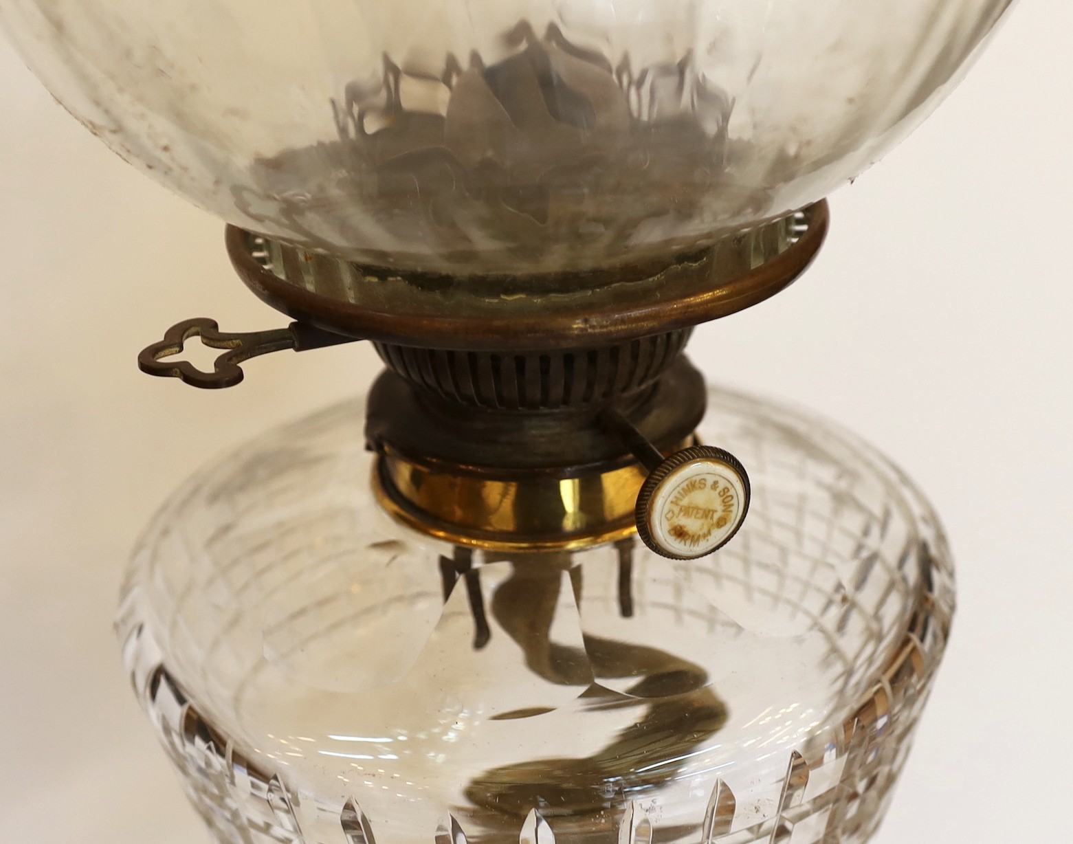 A late Victorian brass and cut glass oil lamp with Hinks and Son mechanism, spiral fluted globe and flue, height overall 74cm